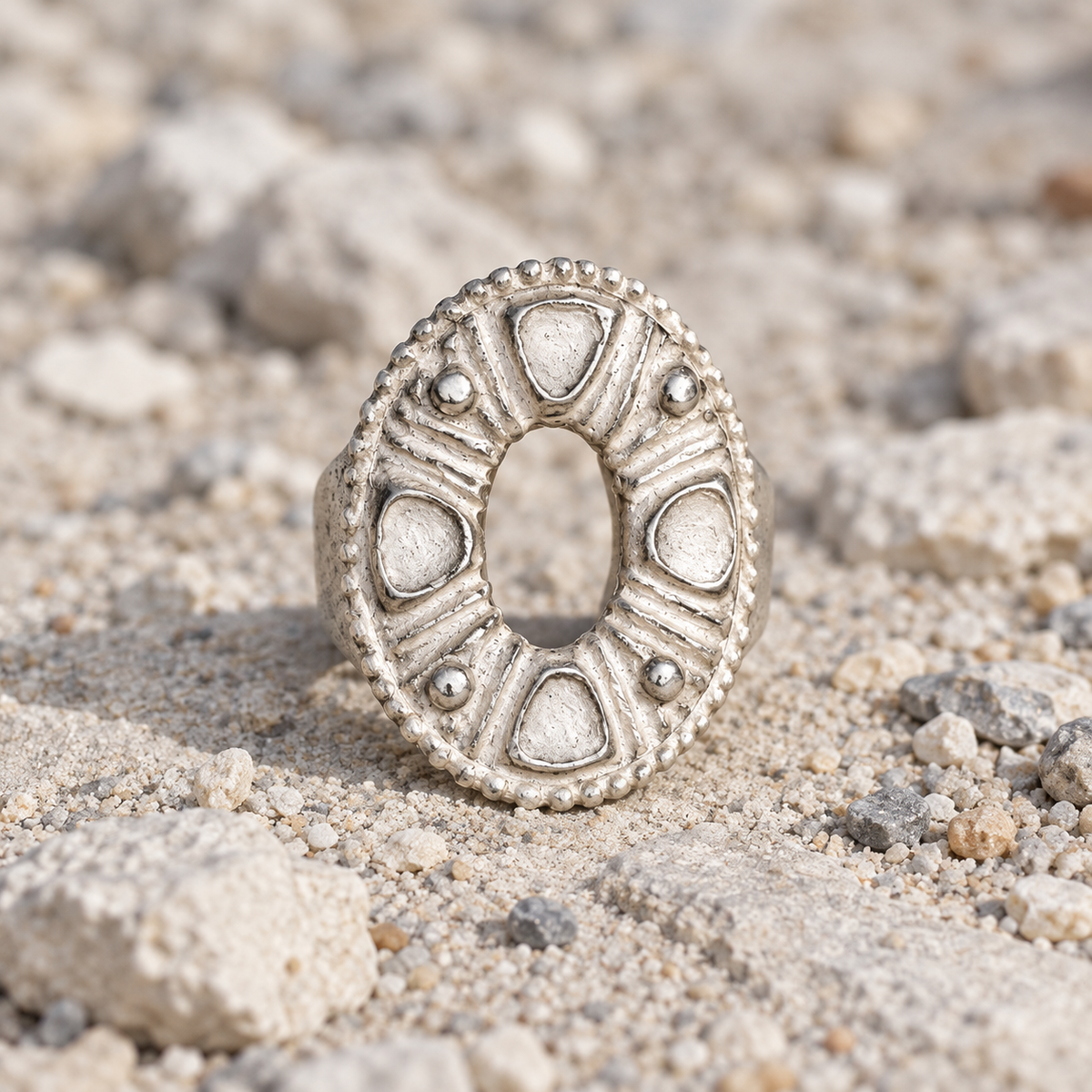 ANHOLANDO Oval Relief Ring on pale coastal gravel